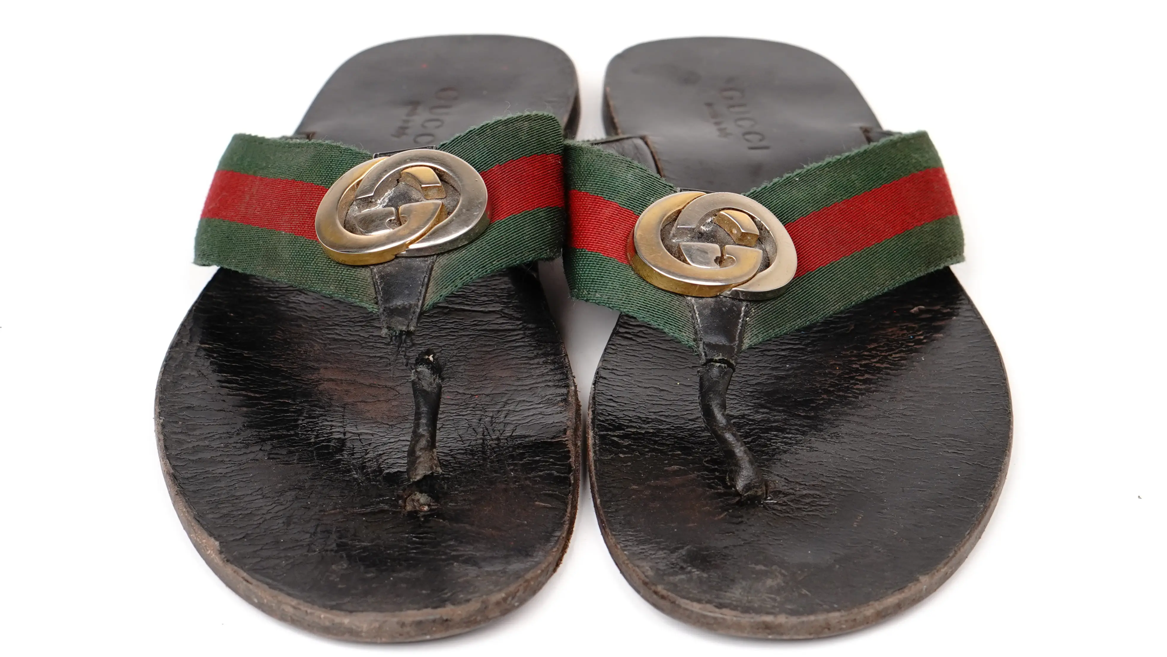 After Gucci slippers restoration repaired PU surface with restored colour depth and refined sheen