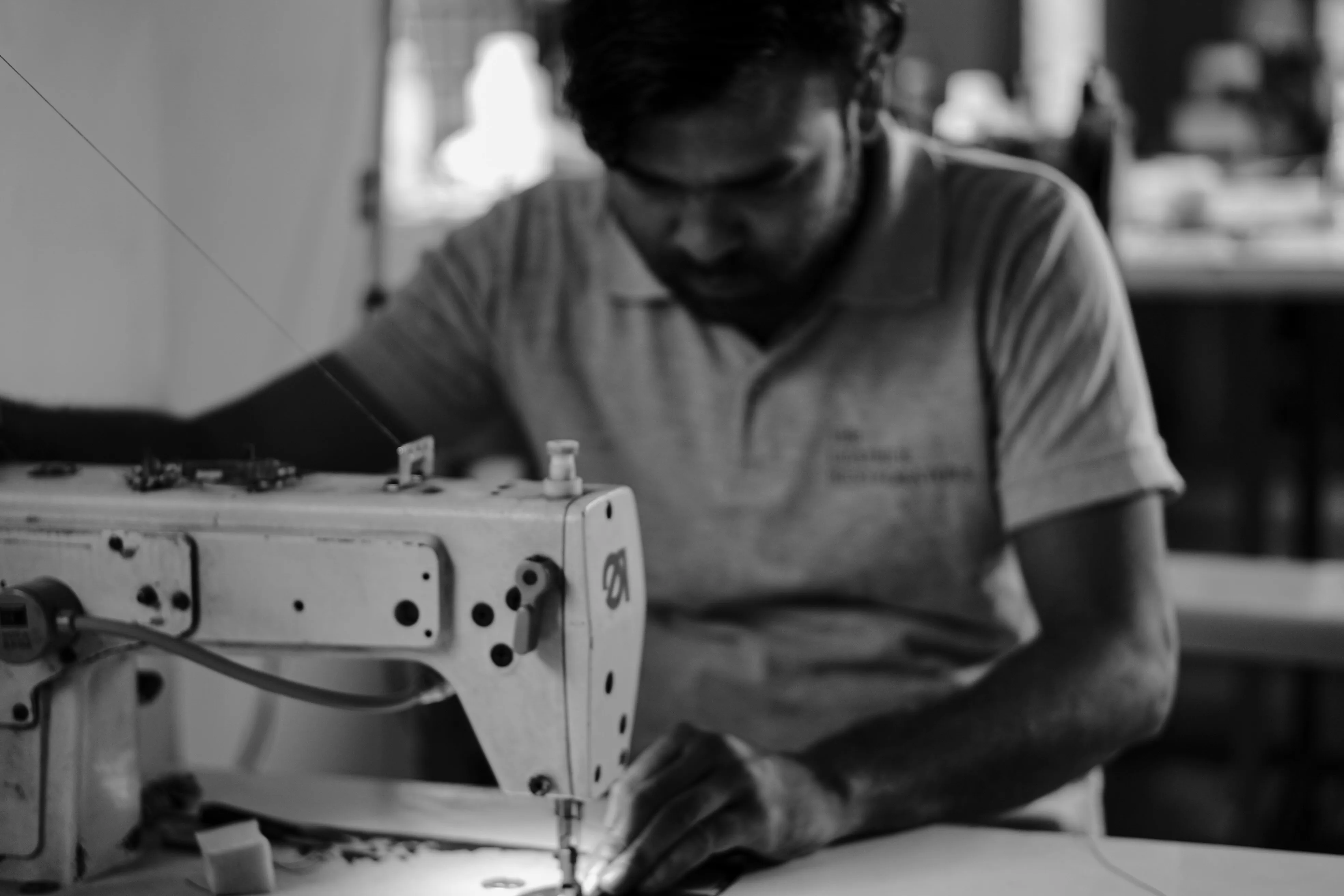 Artisan restoring a Saint Laurent and Hermès leather jacket at The Leather Restorators atelier, Delhi NCR